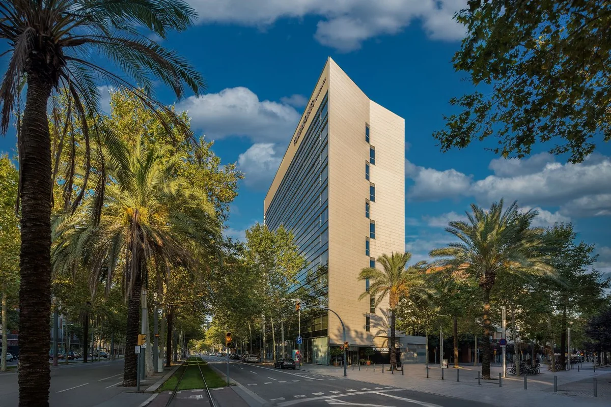 Four Points by Sheraton Barcelona Diagonal, framed by palm trees